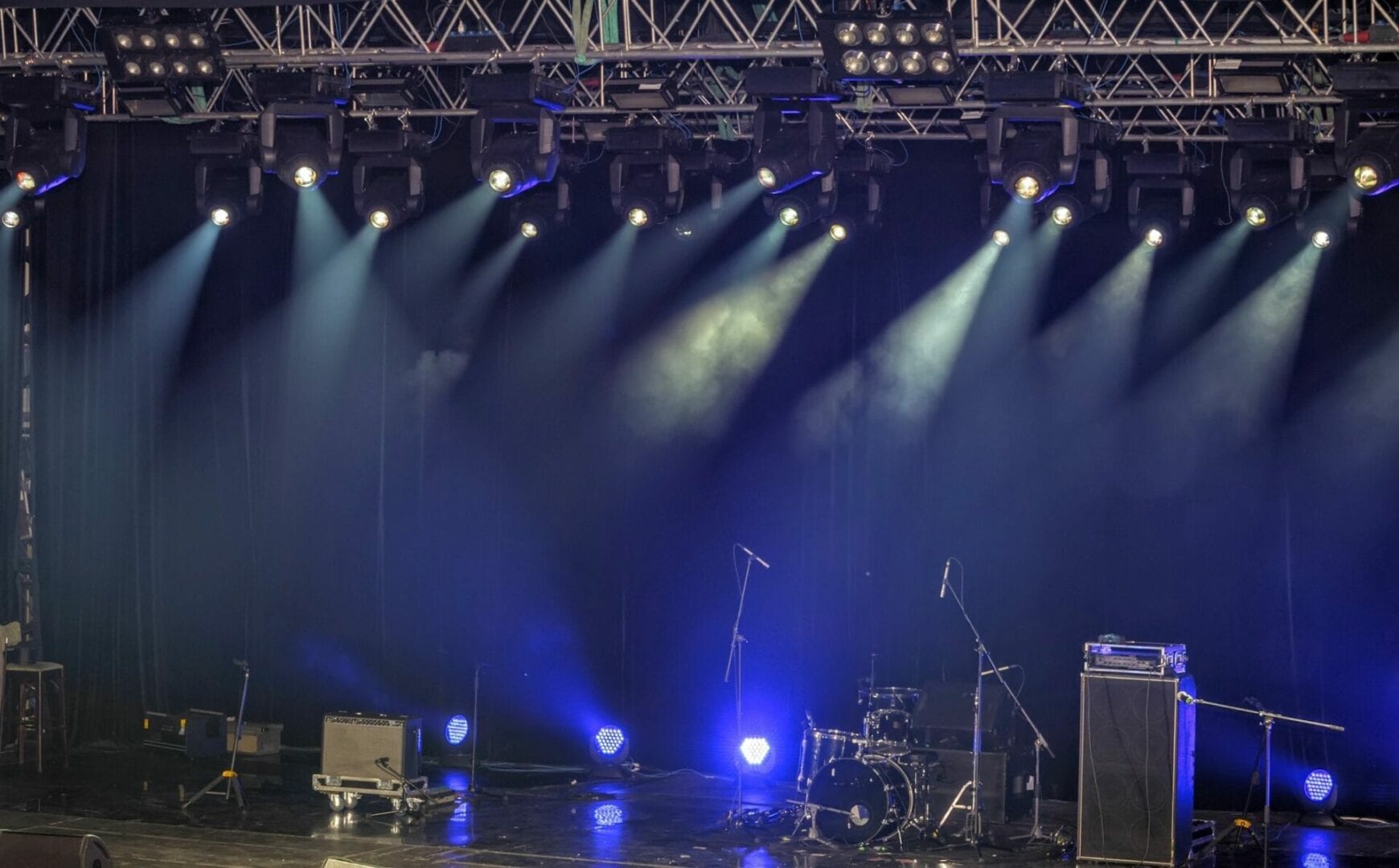 A stage with lights and a band playing.