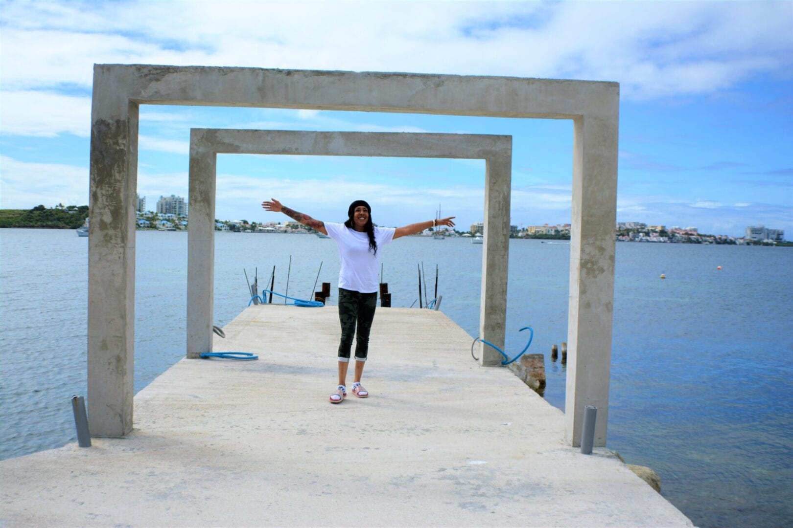 A woman standing on the end of a pier.