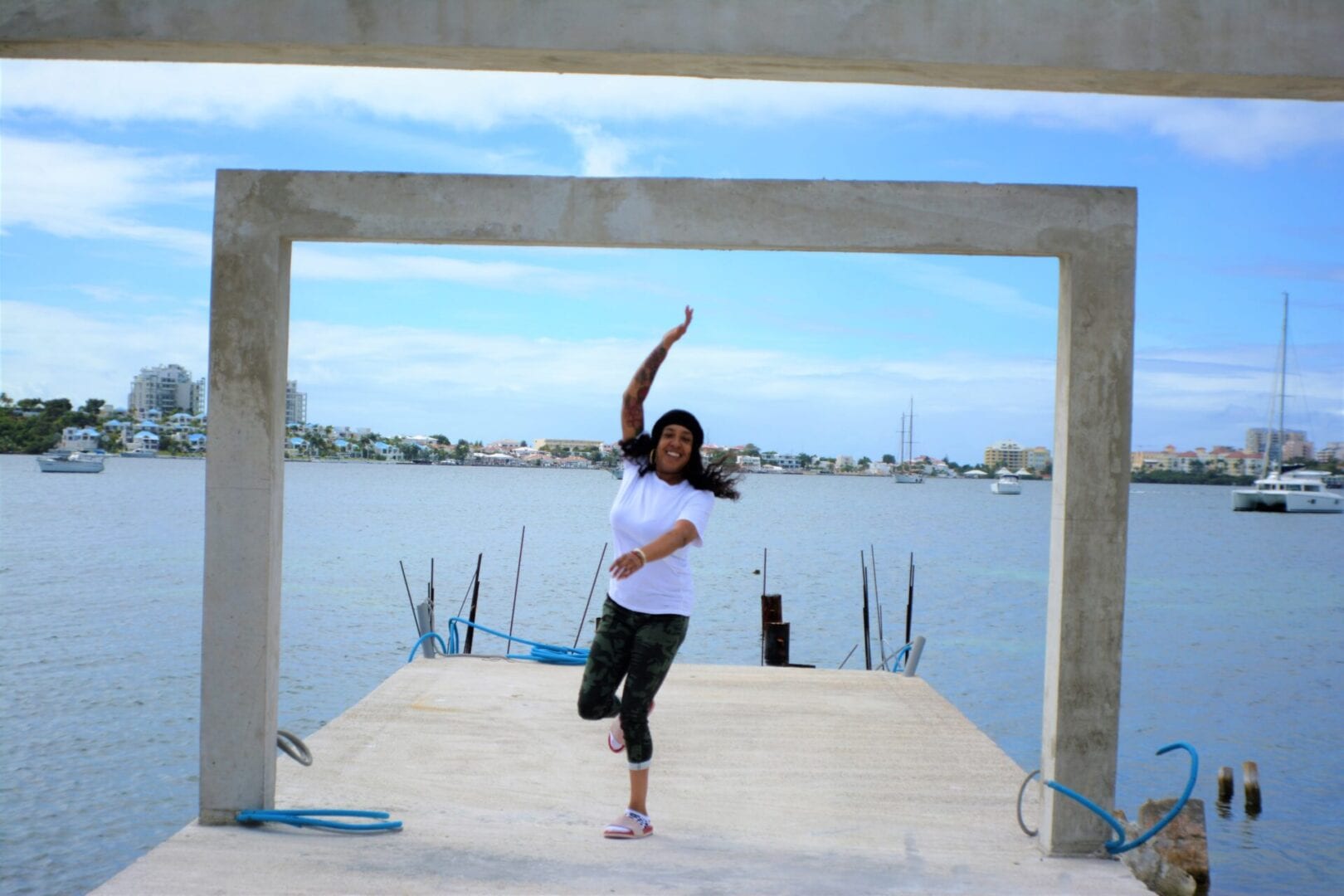A woman is doing yoga on the dock
