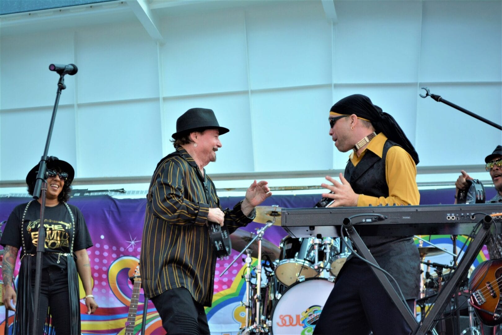 Two men are performing on stage with a microphone.