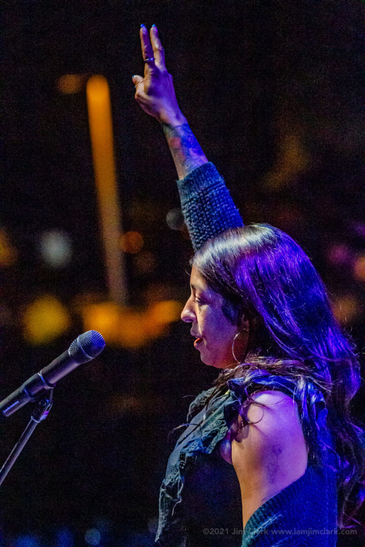 A woman is holding her arms up in the air.