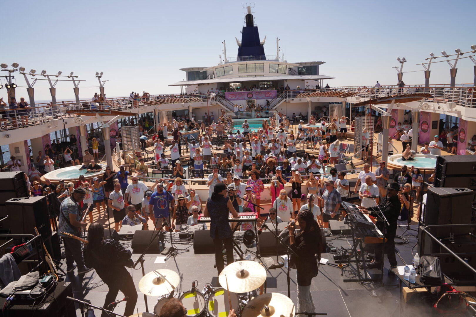 A crowd of people on the beach with musical instruments.